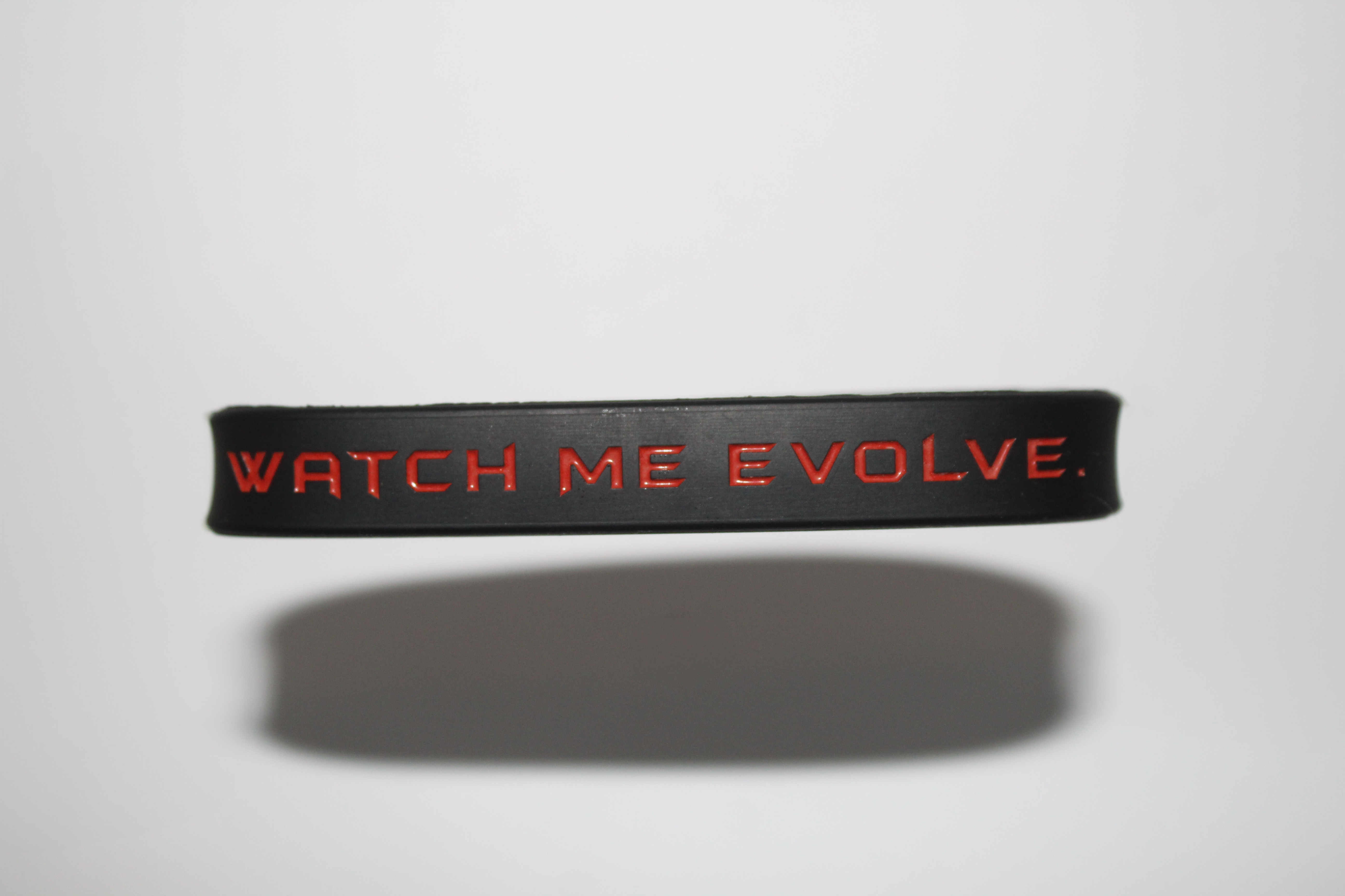 "Watch Me Evolve." Black Wristbands